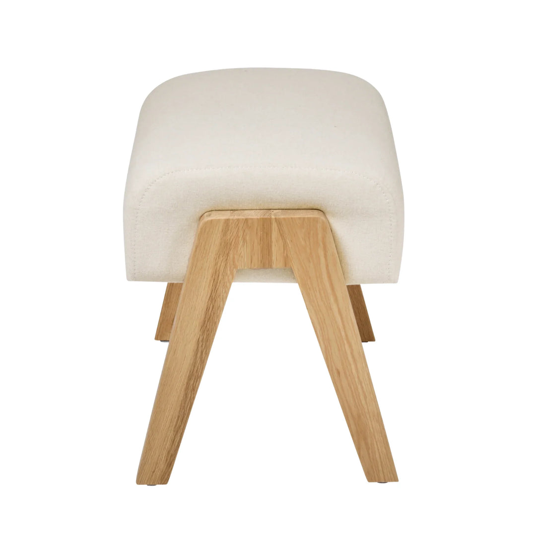 Side shot of the Hera Footstool in Barley showcasing real wood grain on legs.