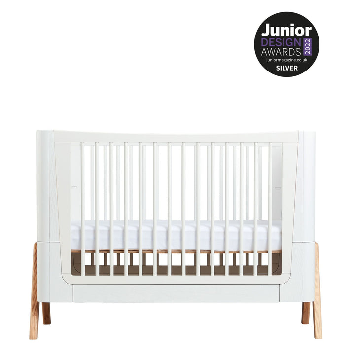 Hera Cot Bed in Scandi White and Natural with a Junior Design Award 2022 silver logo