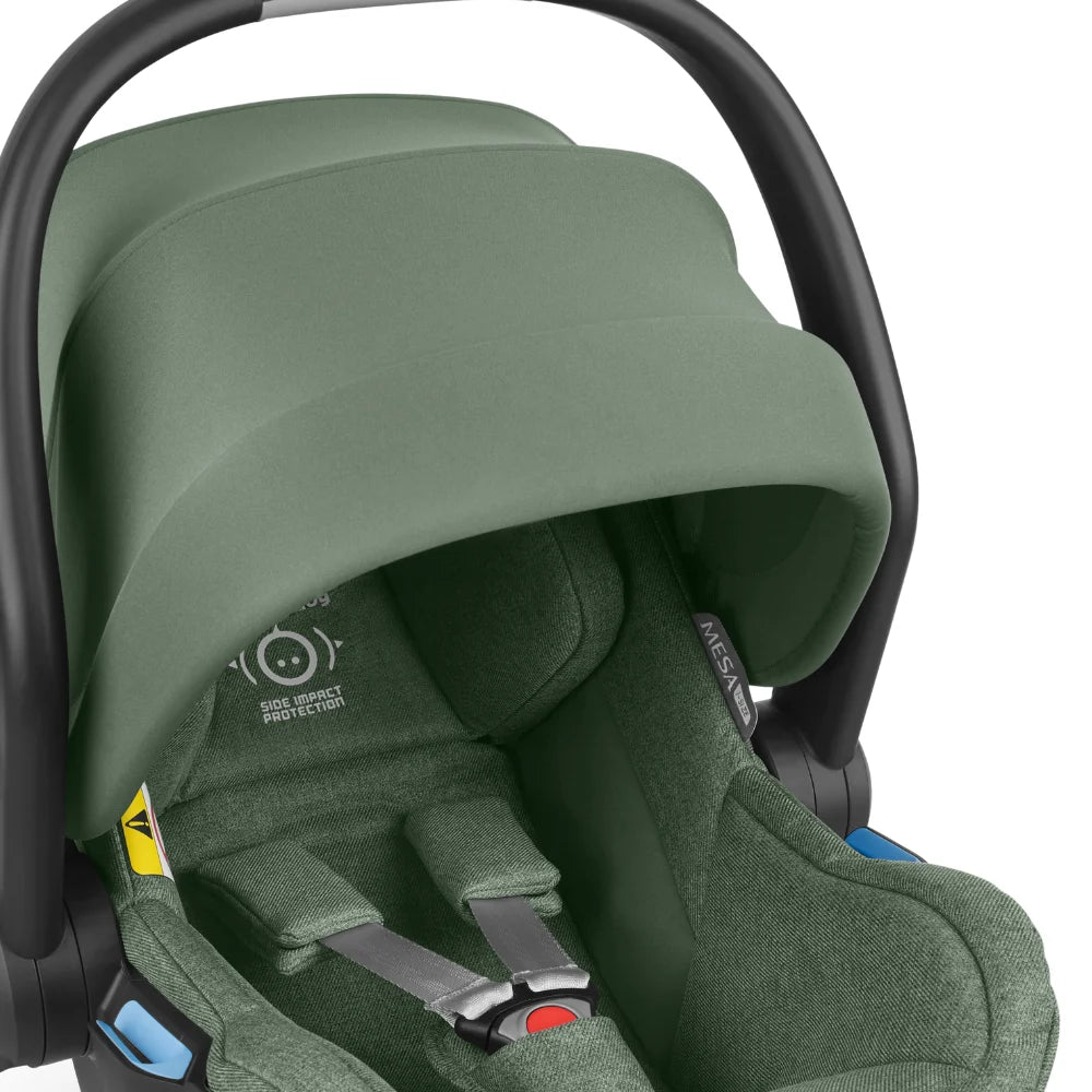 This image shows the Emmett or Gwen fashion of the Mesa i-Size Car Seat with the UPF canopy pulled down to provide shelter from the elements.