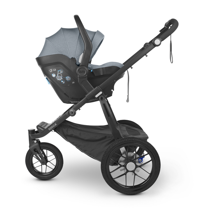 UPPAbaby Mesa iSize infant car seat with kid friendly fabrics and a UPF 25+ extendable canopy in Gregory. This is an image of the car seat on the Ridge chassis with adapters to turn it into a travel system