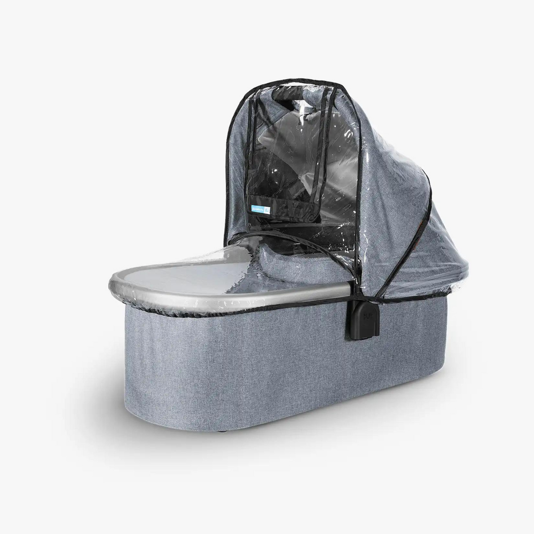 This image shows a carrycot with the rain cover on it.