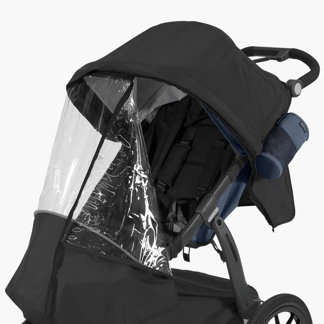 This is an image of the Ridge Performance Rain Shield in use on the Ridge stroller. There is a handy zipper to allow access to your child and it is unzipped to show this feature in this image