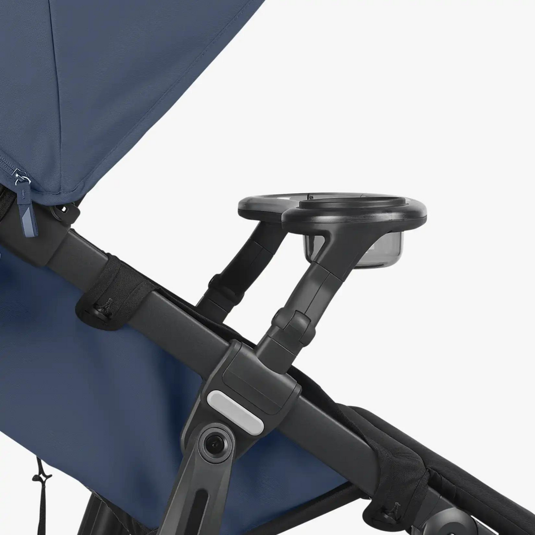 This is a product image side shot of the snack tray on the Ridge stroller, showcasing where it clips onto the stroller frame