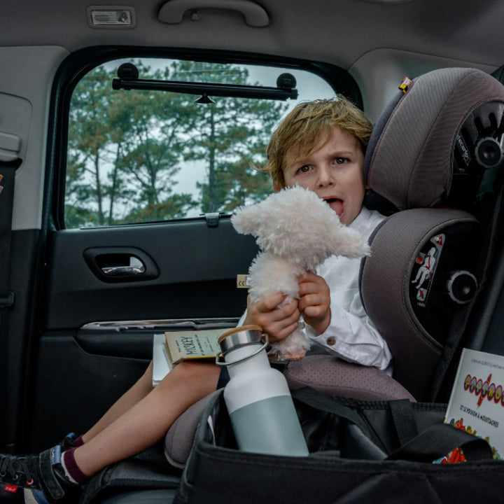 Child in car seat with Ezimoov Ezi Mat 3 in 1 organiser holding drinks and toys