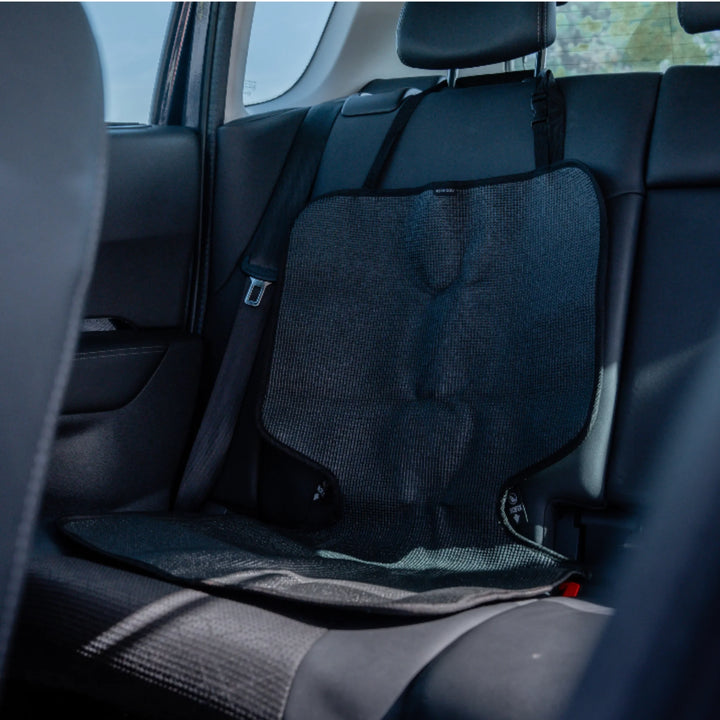 : “Black seat protector on a car’s back seat.”