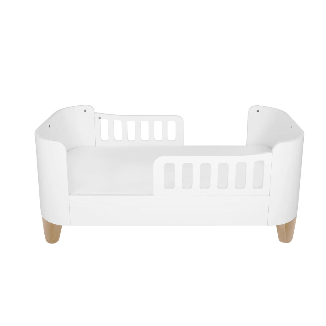 Gaia Baby Serena First Bed with two toddler safety rails and natural wooden legs, showcasing the secure low-to-floor transition bed configuration with the brand’s smooth curved design for toddlers aged 2 years and up.