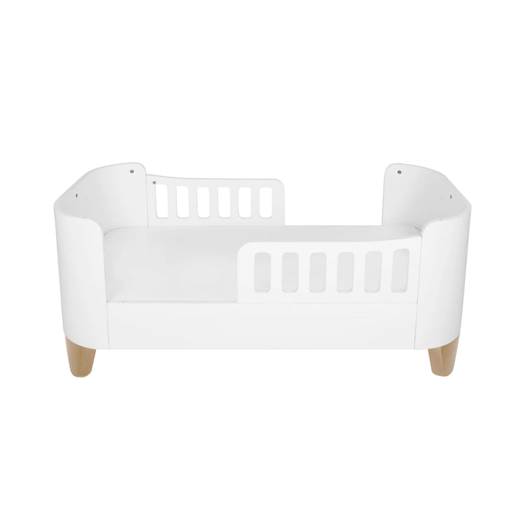 Gaia Baby Serena First Bed with two toddler safety rails and natural wooden legs, showcasing the secure low-to-floor transition bed configuration with the brand’s smooth curved design for toddlers aged 2 years and up.