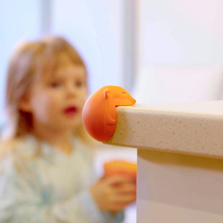 Foxii by Quark silicone fox-shaped corner protector on kitchen counter edge, premium baby-proofing accessory preventing bumps and injuries, keeping toddlers safe in stylish home spaces.