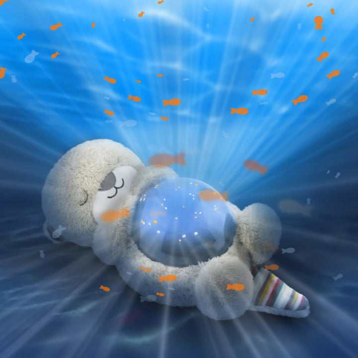 ZAZU Otto the Otter ocean projector night light plush projecting an underwater fish light effect.