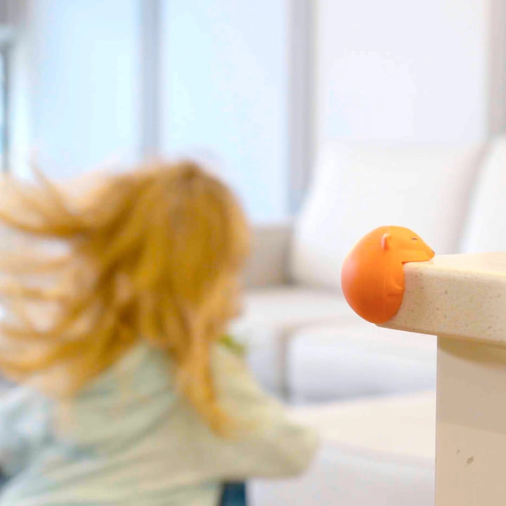 Foxii by Quark silicone fox-shaped corner protector on kitchen countertop edge, baby-proofing solution preventing toddler injuries and adding stylish safety to modern homes.