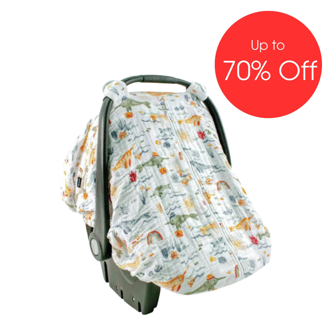 Bebe Au Lait muslin car seat cover in Narwhal ocean-themed print featuring whales, rainbows and sea creatures, breathable zip-front infant car seat canopy displayed with ‘Up to 70% Off’ sale badge.