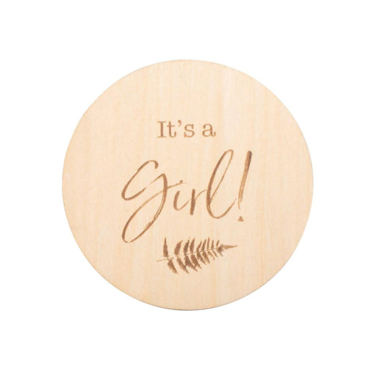 “Wooden ‘It’s a Girl!’ baby announcement milestone disc with engraved fern design, newborn gender reveal photo prop for birth announcements.