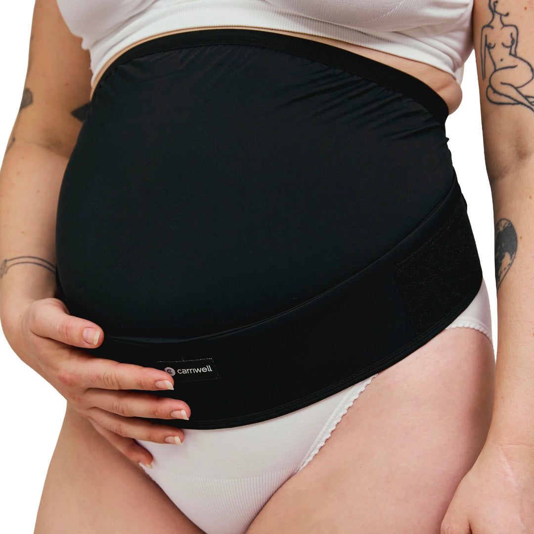 Close-up of Carriwell adjustable maternity support belt in black, showing under-bump pregnancy belly support, breathable stretch fabric and secure fit for back and pelvic support during pregnancy.