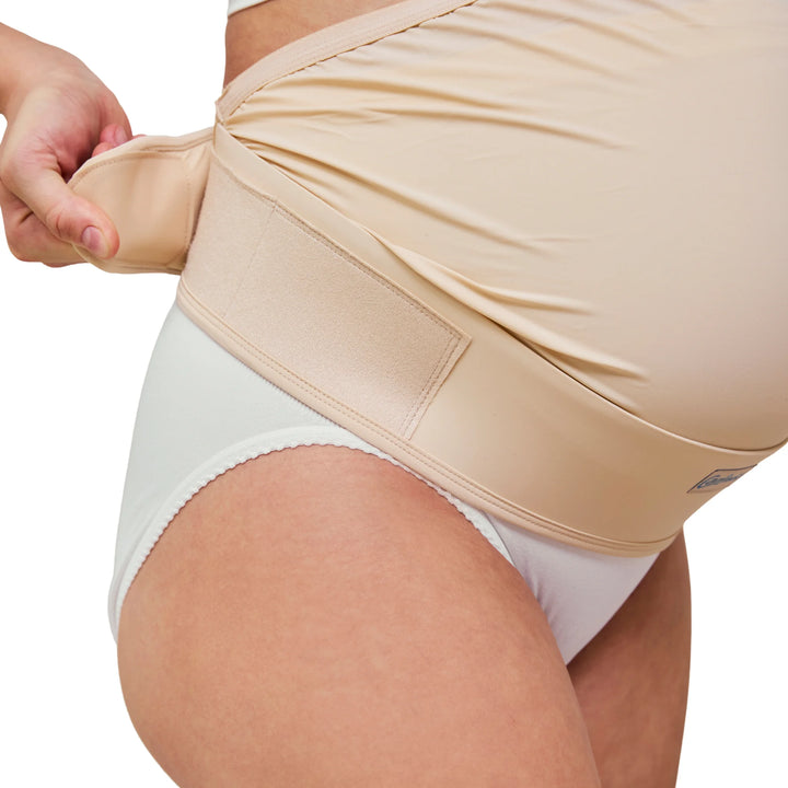 Close-up of Carriwell adjustable maternity support belt in honey colour, showing secure hook-and-loop fastening and flexible abdominal support designed to relieve pregnancy back and pelvic discomfort.