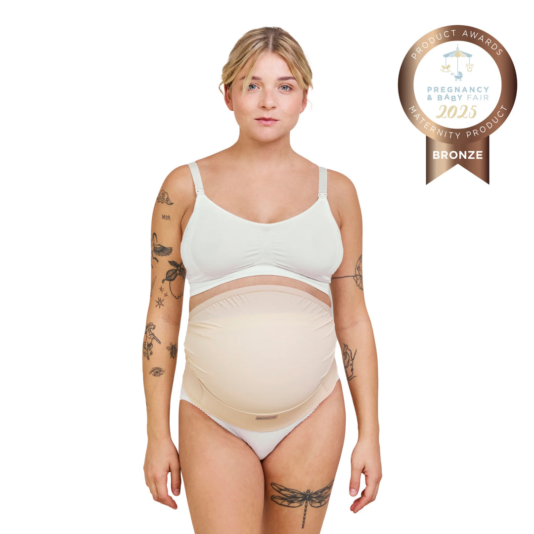 Front view of Carriwell adjustable maternity support belt in honey colour, worn over pregnancy bump, providing gentle belly and lower back support; award-winning maternity support belt designed to relieve pelvic and back pain during pregnancy.
