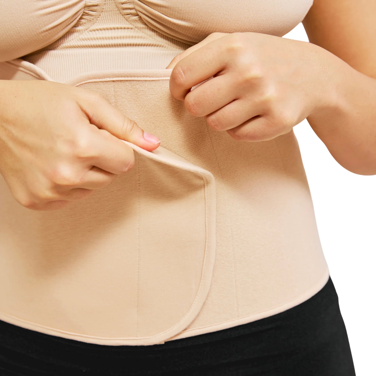 Close-up of Carriwell honey belly binder showing adjustable Velcro closure and targeted postpartum abdominal compression for core support and recovery after pregnancy.