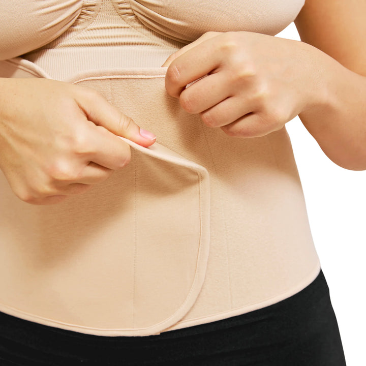 Close-up of Carriwell honey belly binder showing adjustable Velcro closure and targeted postpartum abdominal compression for core support and recovery after pregnancy.