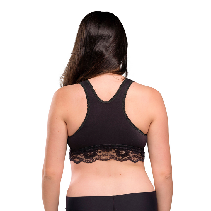 This image shows the back of the crossover bra in black on a model, showing the comfy back and lace detail.