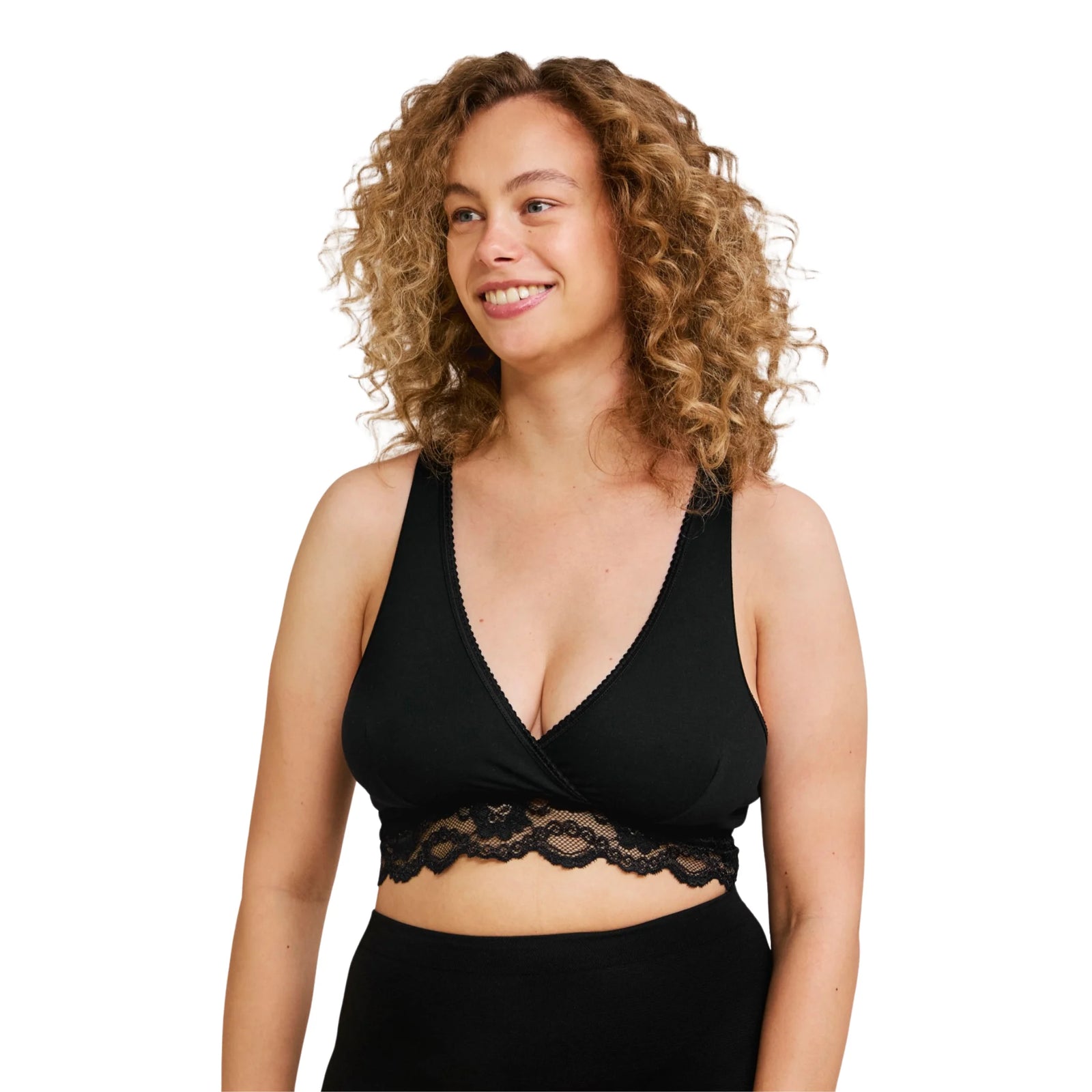 Woman wearing a black Carriwell crossover sleeping and nursing bra with lace underband, offering soft support and easy breastfeeding access for pregnancy and postpartum.