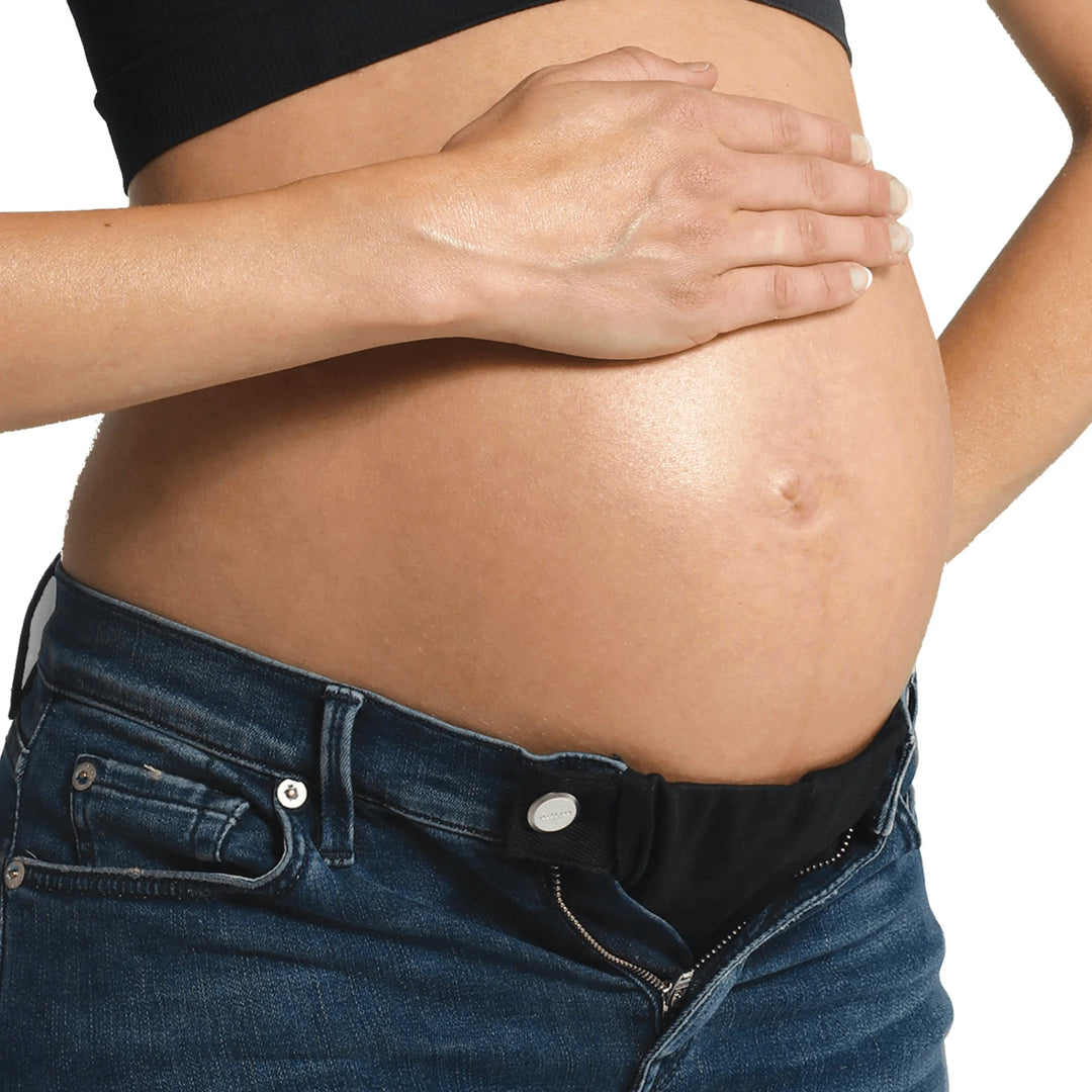 Carriwell flexibelt waist expander in use on jeans with black fabric.