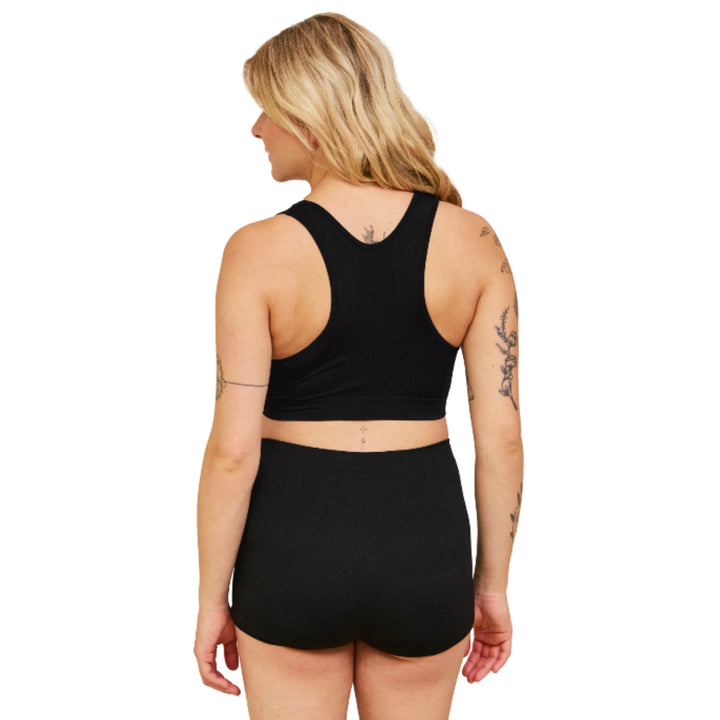 Back view of a pregnant woman wearing Carriwell maternity hospital pants in black, showing the seamless, breathable fit designed for comfort, flexibility and support during labour, hospital stays and post-birth recovery.