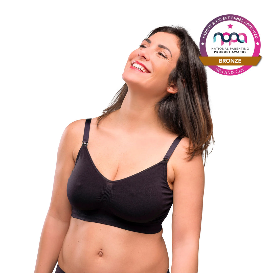 Smiling mother wearing ClevaMama Maternity and Nursing Bra in black – award-winning seamless breastfeeding bra with easy clip-down cups, soft stretch fabric for comfort and support, Bronze winner at National Parenting Product Awards 2025 Ireland.