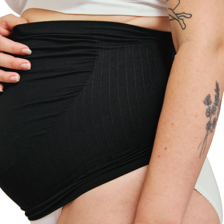 Close-up of black Carriwell maternity support band showing soft stretch fabric and seamless over-bump design for gentle belly and lower back support during pregnancy.