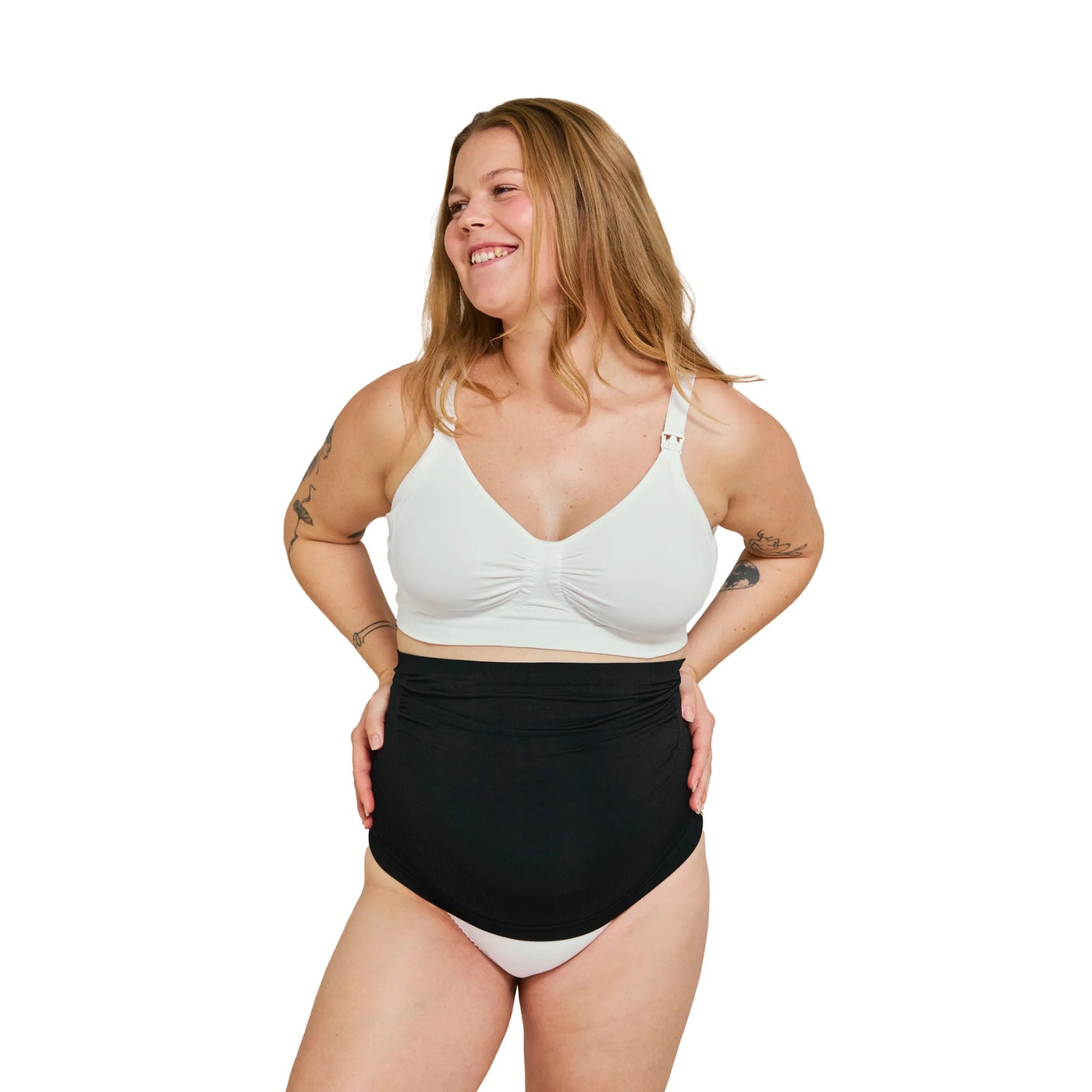 Front view of pregnant woman wearing black Carriwell maternity support band over the bump, designed to provide adjustable belly and lower back support during pregnancy.