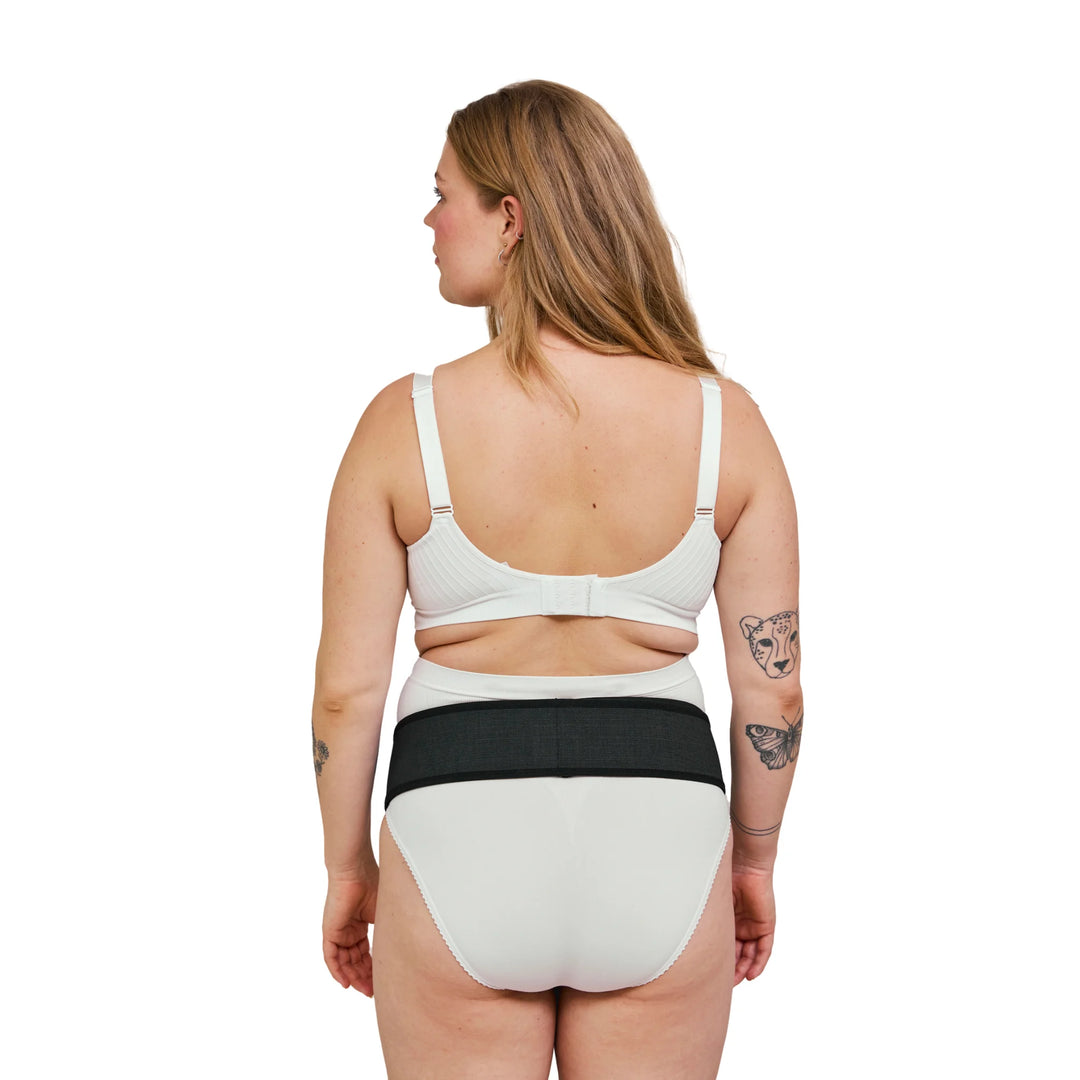 Back view of the maternity support belt on a pregnant woman.