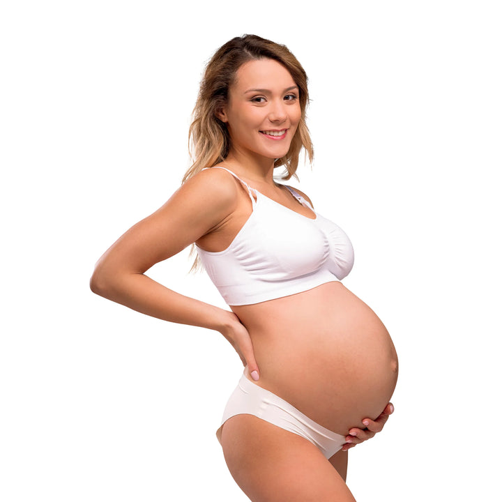 Pregnant woman wearing carriwell padded maternity and nursing bra on a white background.