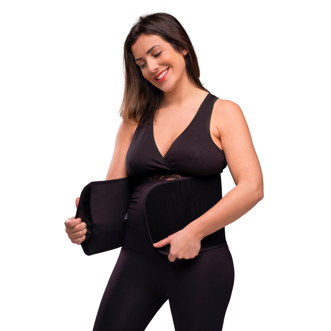 This image shows a model putting on the post birth belly binder.