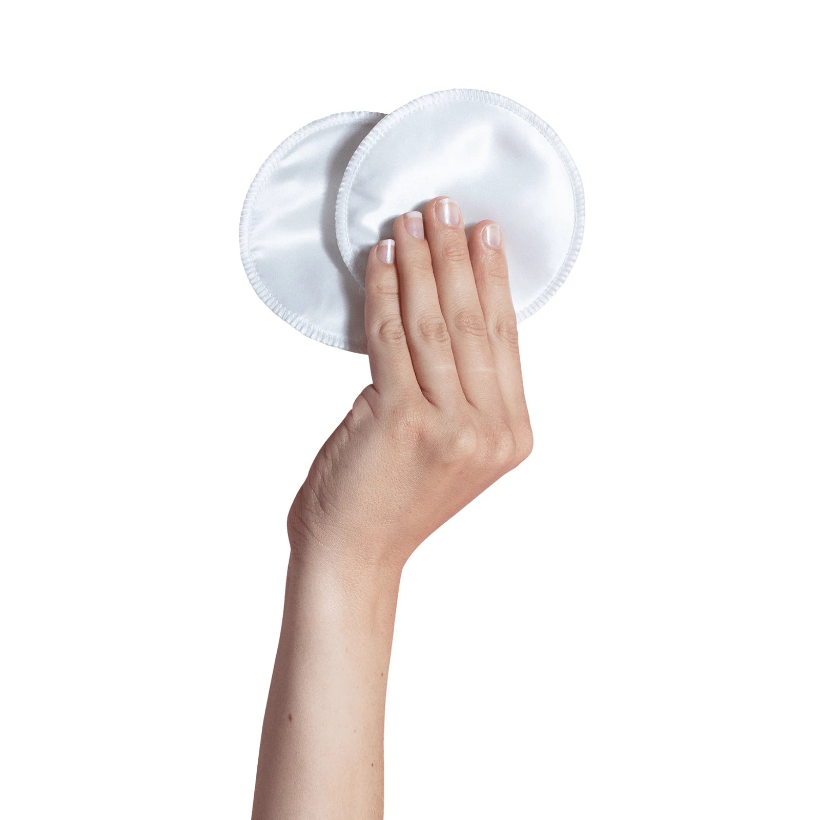 hand holding Carriwell silk reusable breast pads