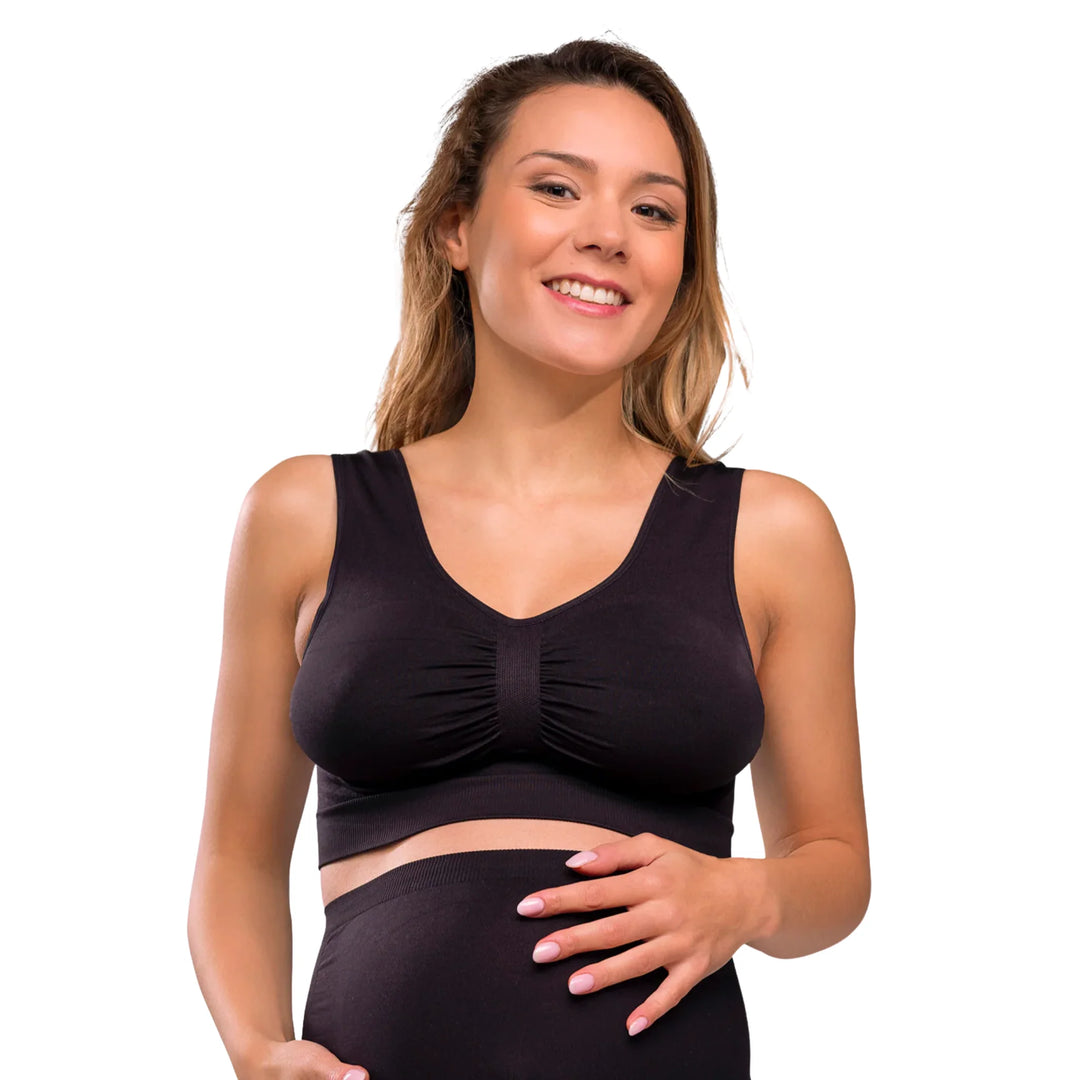 Woman wearing a black Carriwell seamless maternity bra, providing comfortable stretch support for pregnancy and everyday wear.