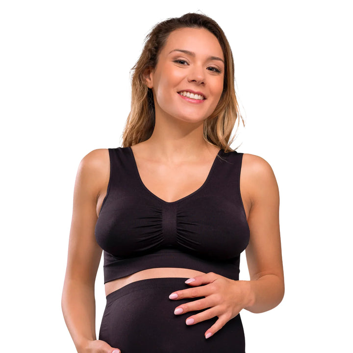 Woman wearing a black Carriwell seamless maternity bra, providing comfortable stretch support for pregnancy and everyday wear.
