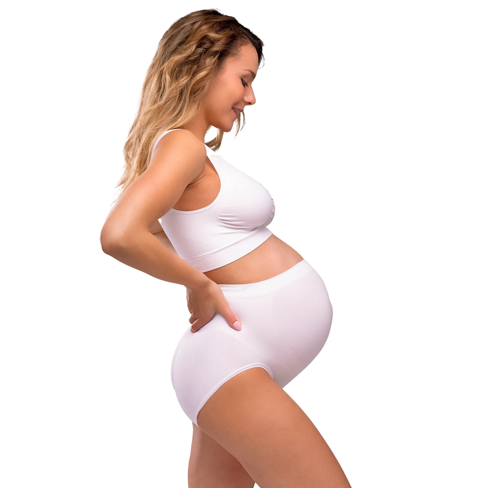 Side view of pregnant woman wearing a white Carriwell seamless maternity bra, offering stretch support and comfortable fit throughout pregnancy.