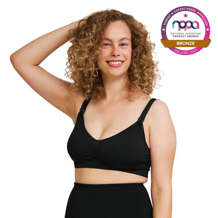 Woman wearing a black maternity and feeding bra with a bronze NPPA award badge on a white background