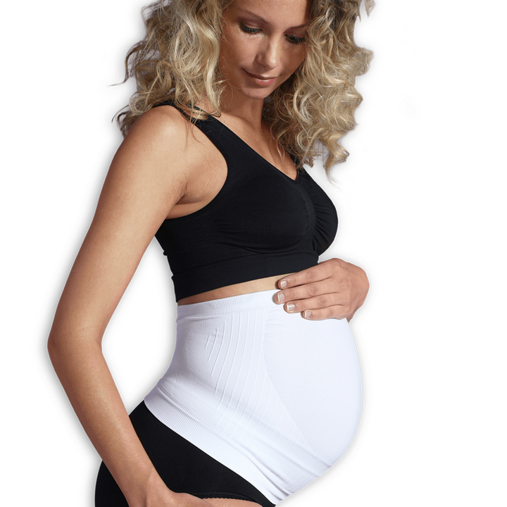 This is an image of a pregnant model wearing the Carriwell seamless maternity support band in white.