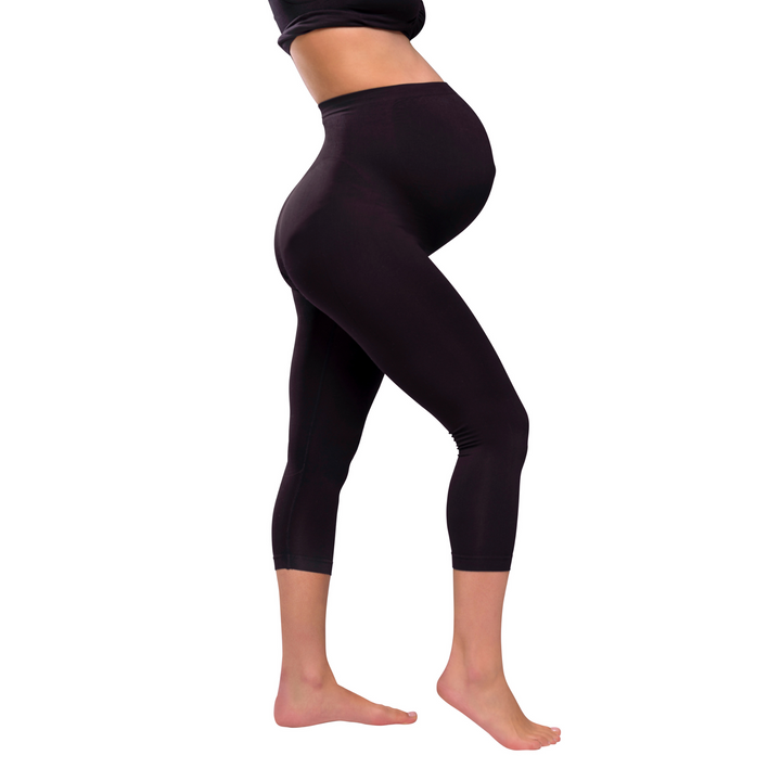 This image is a side on shot of a model wearing the Carriwell three quarter length maternity support leggings.