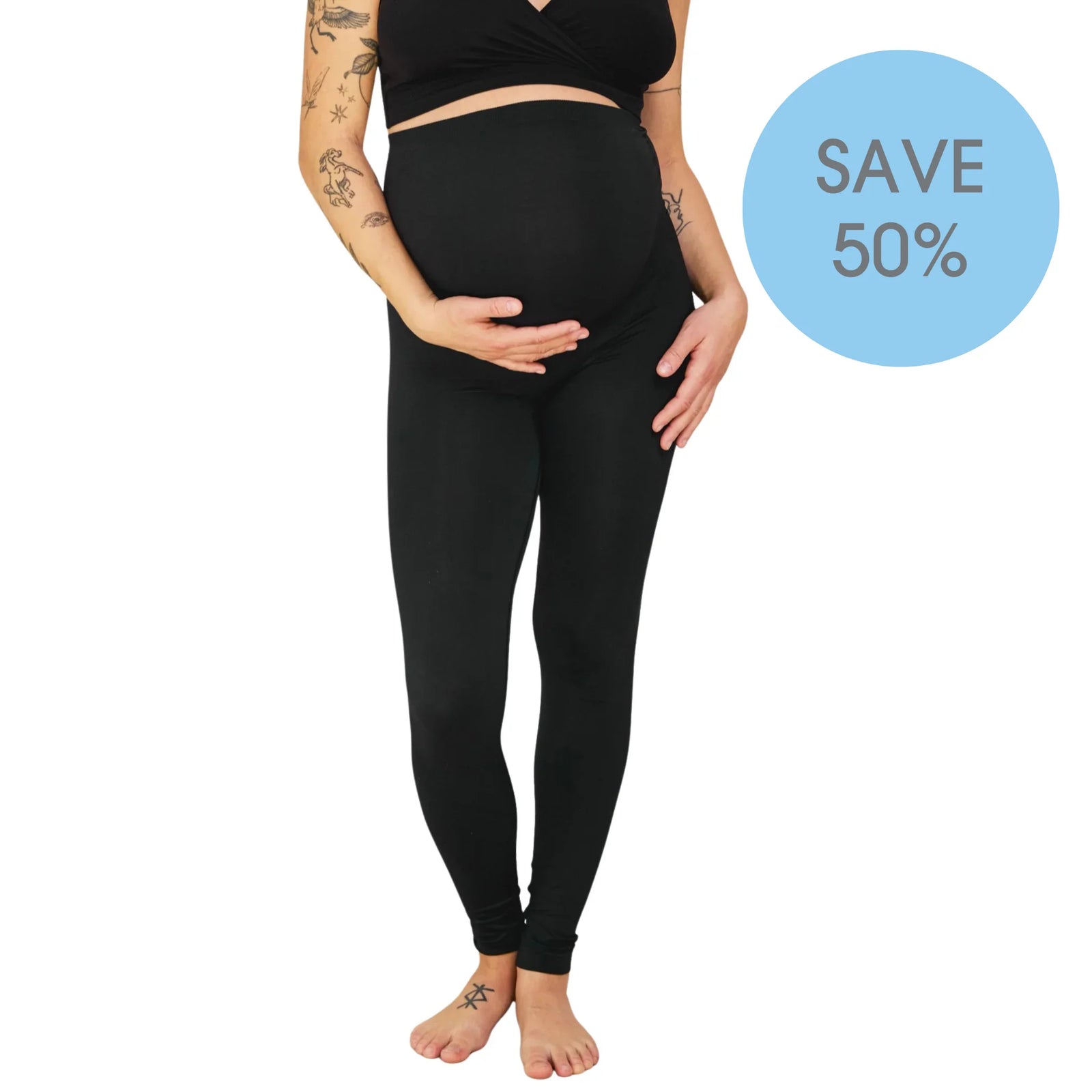 Model wearing Carriwell black maternity support leggings with over-bump belly panel, “Save 50%” offer badge.
