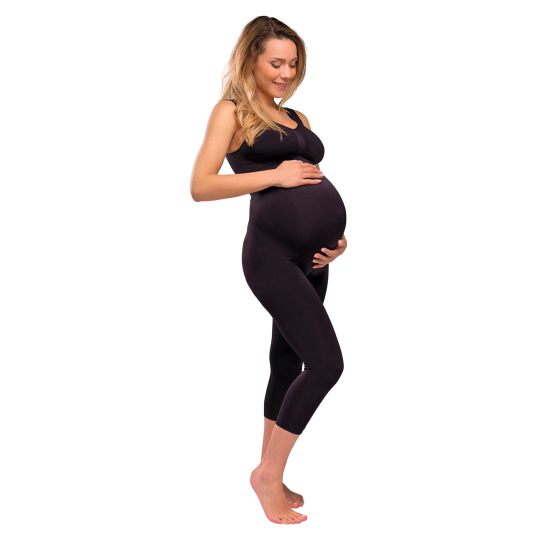 Angled view of model wearing Carriwell three-quarter length maternity support leggings in black, featuring a high-waisted over-bump design that provides gentle belly support and comfort throughout pregnancy.