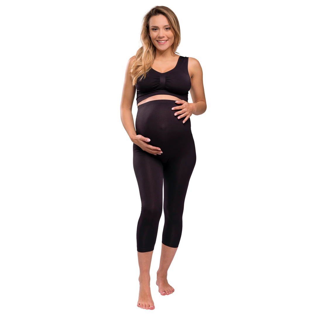 Front view of model wearing Carriwell three-quarter length maternity support leggings in black, featuring a high-waisted over-bump design for pregnancy support, comfort and everyday wear.