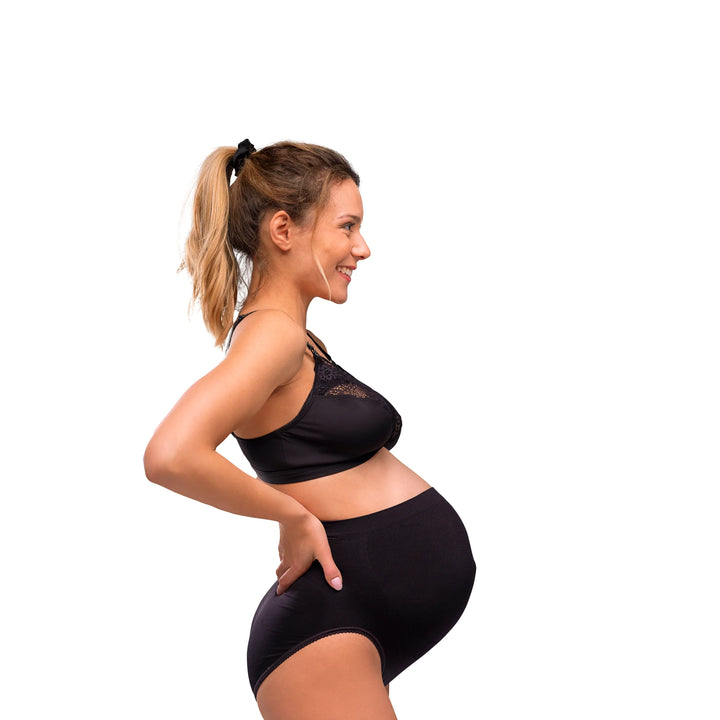 Side view of a pregnant model wearing the black Carriwell Soft As Silk nursing bra with lace detailing, offering soft, flexible support for pregnancy and breastfeeding.