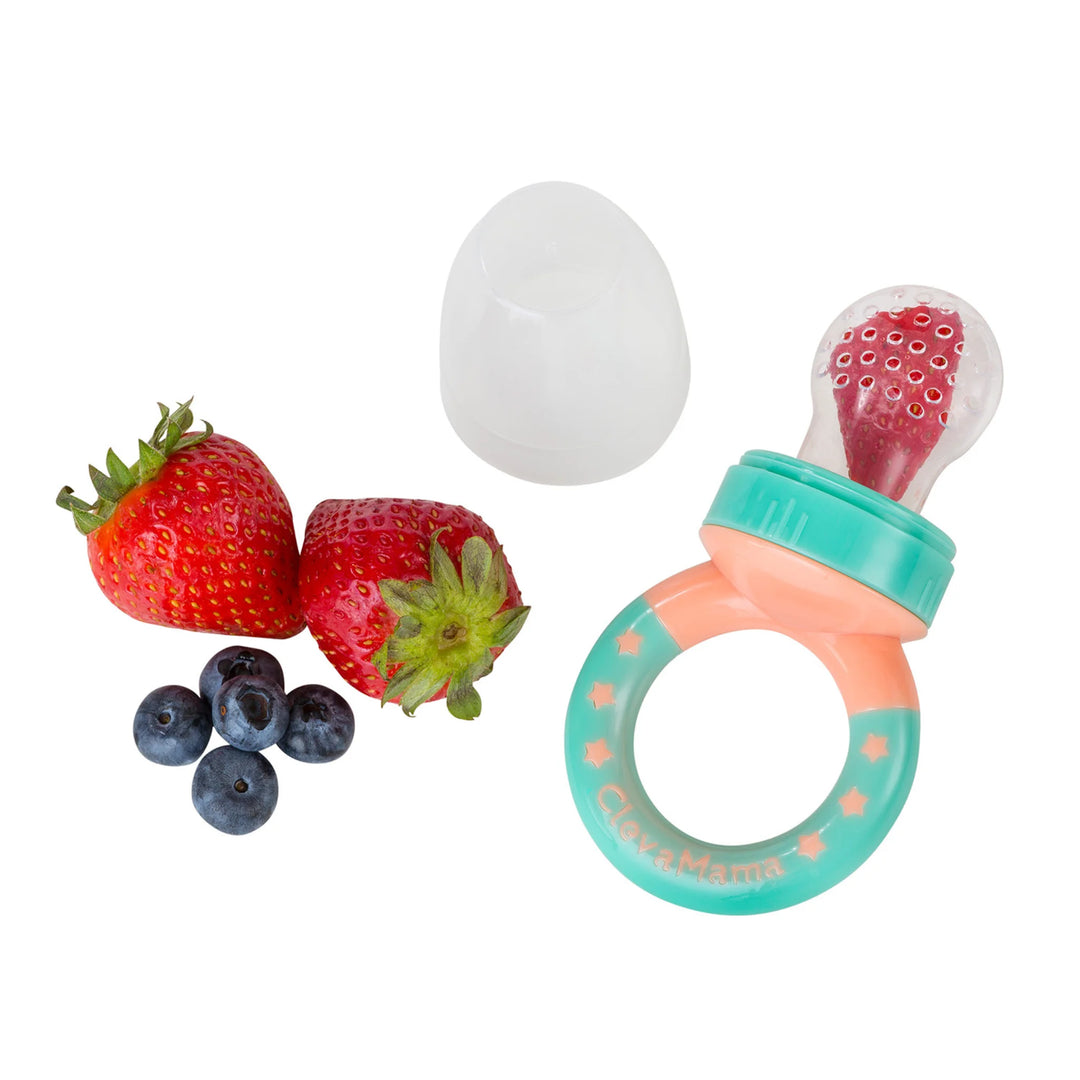 ClevaMama ClevaFeed fruit feeder with strawberries and blueberries, showing silicone feeder filled with fruit and separate cap on a white background.