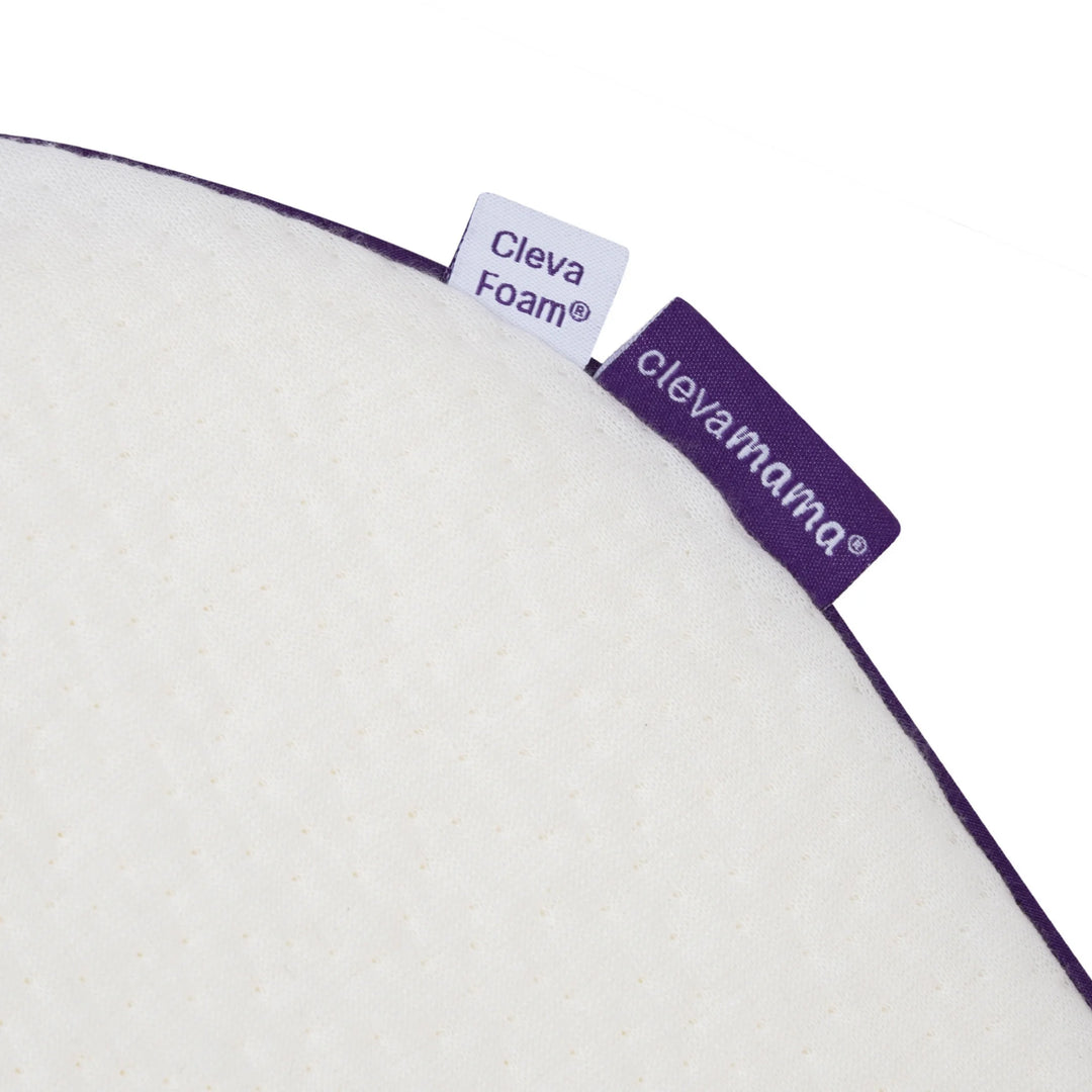 Close-up of ClevaMama ClevaFoam Elevated Support corner showing premium breathable fabric and brand labels — high-quality baby sleep positioner designed for reflux relief, gentle elevation, and safe, comfortable infant rest.