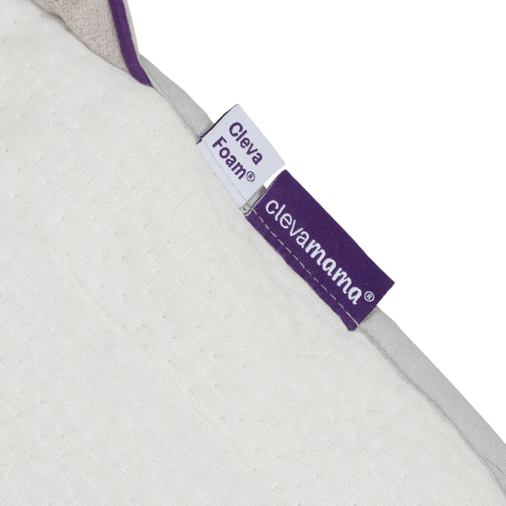 ClevaMama ClevaFoam Head and Neck Support label close-up — premium quality baby support cushion featuring ClevaMama logo and ClevaFoam material tag. Highlights authentic brand design, soft breathable fabric, and durable stitching on ergonomic newborn head and body support pillow.