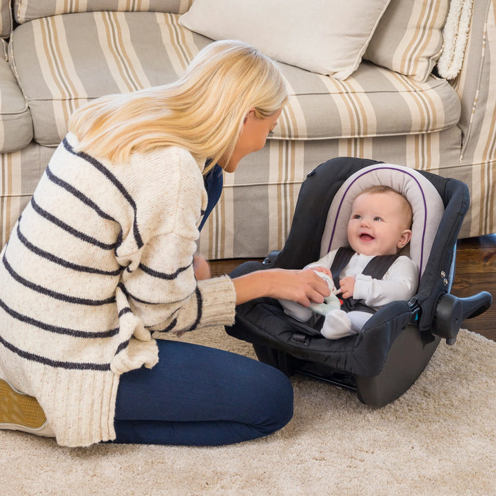 ClevaMama ClevaFoam Head and Neck Support — baby sitting in car seat with ergonomic ClevaFoam insert, smiling up at parent. Soft, breathable, and hypoallergenic baby head and neck support cushion designed to prevent flat head syndrome, offering comfort and stability for newborns in car seats, strollers, and bouncers