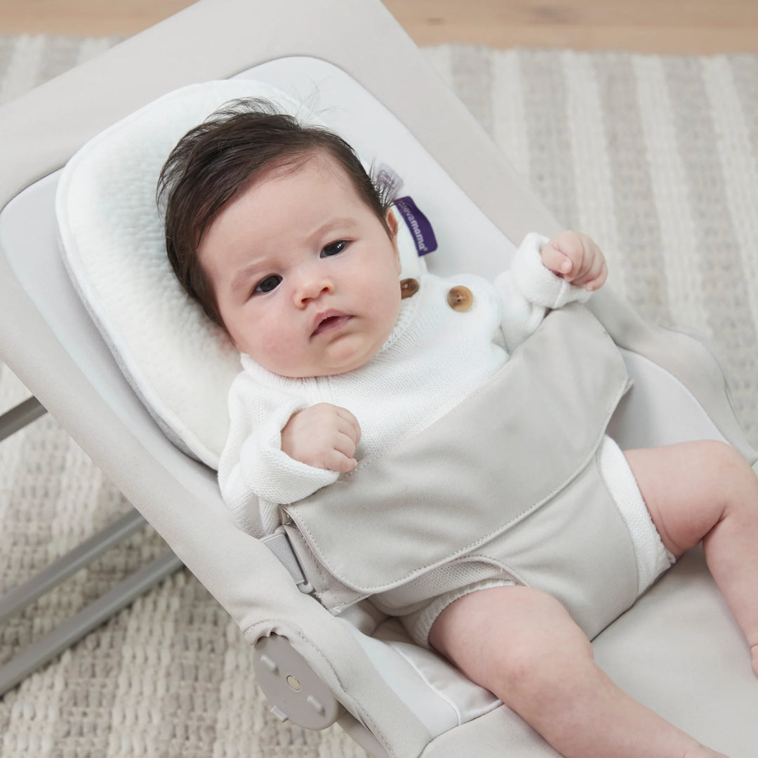 Baby resting on ClevaMama ClevaFoam Infant Pillow – supportive breathable memory foam baby pillow designed to prevent flat head syndrome, ideal for newborn comfort and safe sleep support.