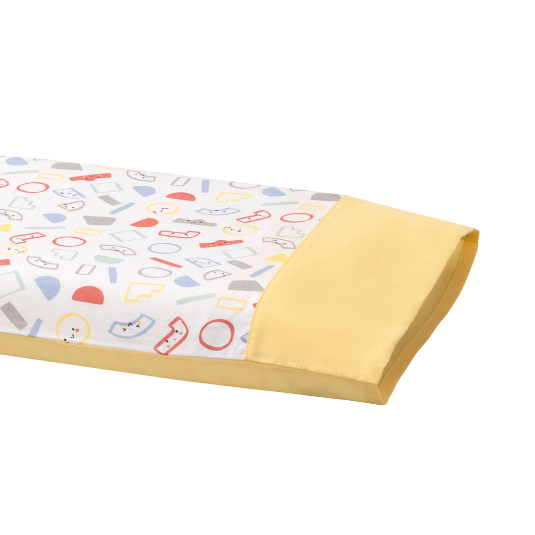Close-up of ClevaMama ClevaFoam Toddler Pillow with yellow and grey cotton pillowcase – soft, breathable fabric featuring colourful geometric pattern. Hypoallergenic and machine-washable toddler pillow cover designed for safe, comfortable sleep