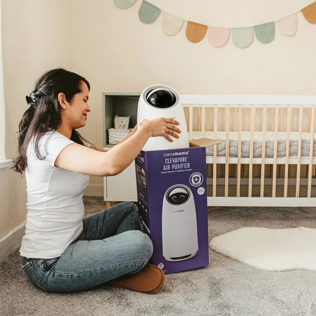 ClevaMama ClevaPure Air Purifier being unboxed in baby nursery — medical-grade HEPA H13 filter removes 99.95% of airborne allergens, dust, pollen, bacteria, and odours for cleaner, healthier air for families.