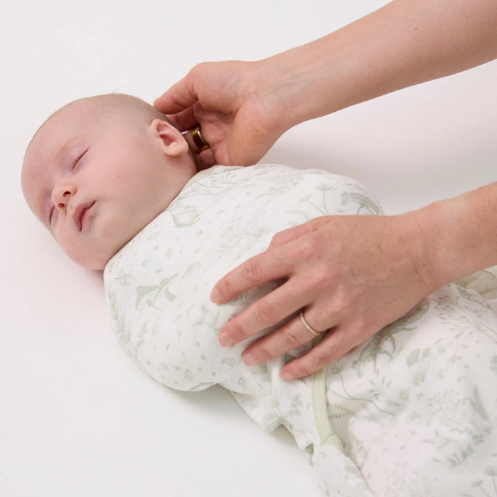Sleeping baby swaddled in ClevaMama ClevaSleep Forest Friends swaddle sleeping bag, newborn sleep sack